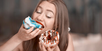 Reprezentare a creierului uman reacționând la consumul de zahăr, ilustrând neurobiologia poftei și eliberarea de dopamină.